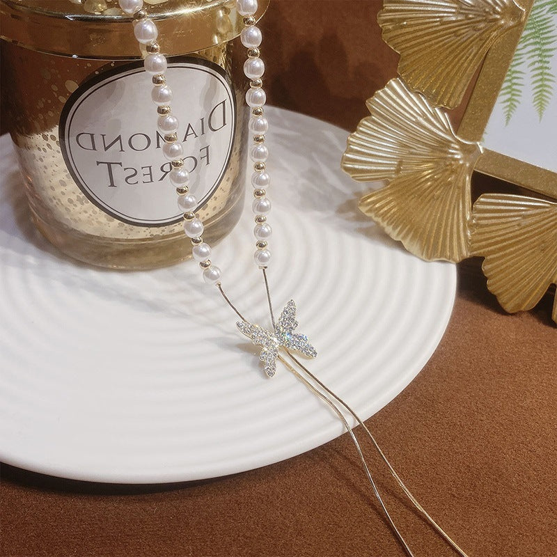 Long butterfly pearl necklace